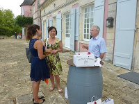 groupe de gens discutant devant un château viticole